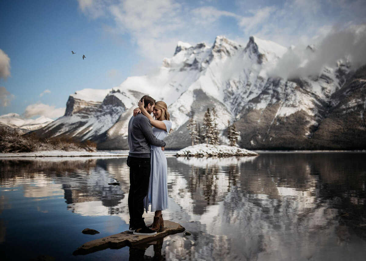 Moody portrait of couple in the mountains captured by TkShotz, modern wedding photographer and videographer in Calgary, Alberta. Featured on the Bronte Bride Vendor Guide.