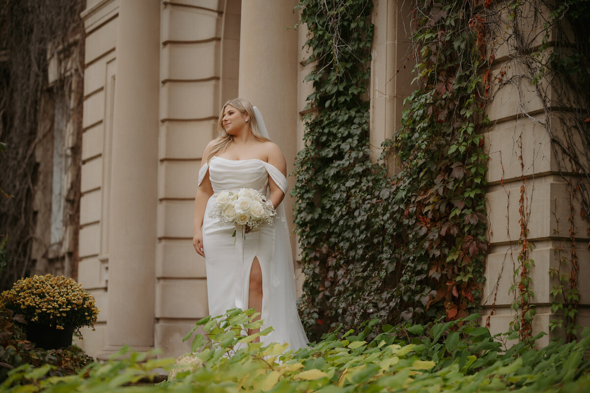 bride posing on steps of fines arts building in edmonton