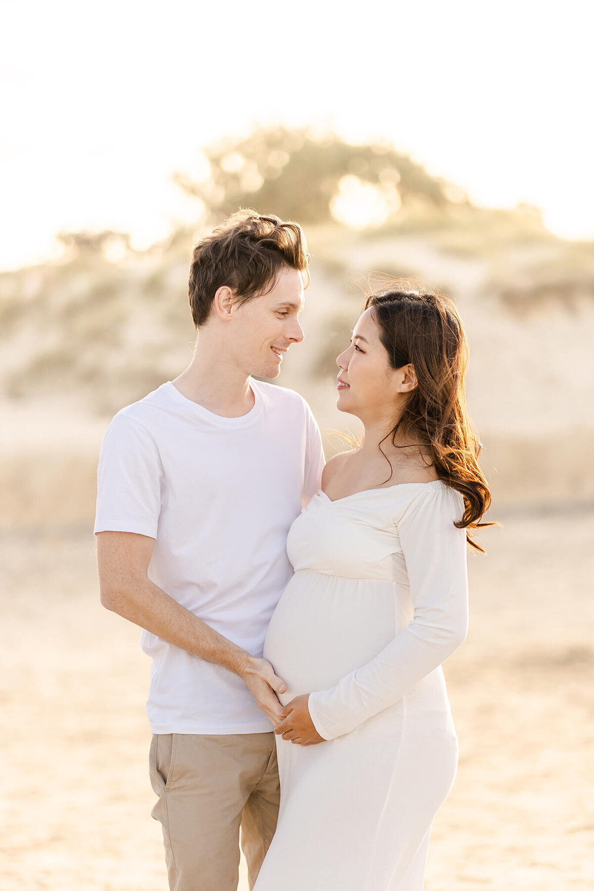 Cute couple sharing intimate look during maternity photoshoot in Gold Coast QLD