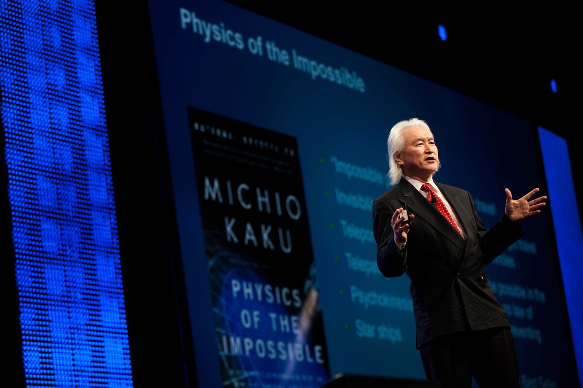 Michio Kaku speaks on stage lit by stage lighting