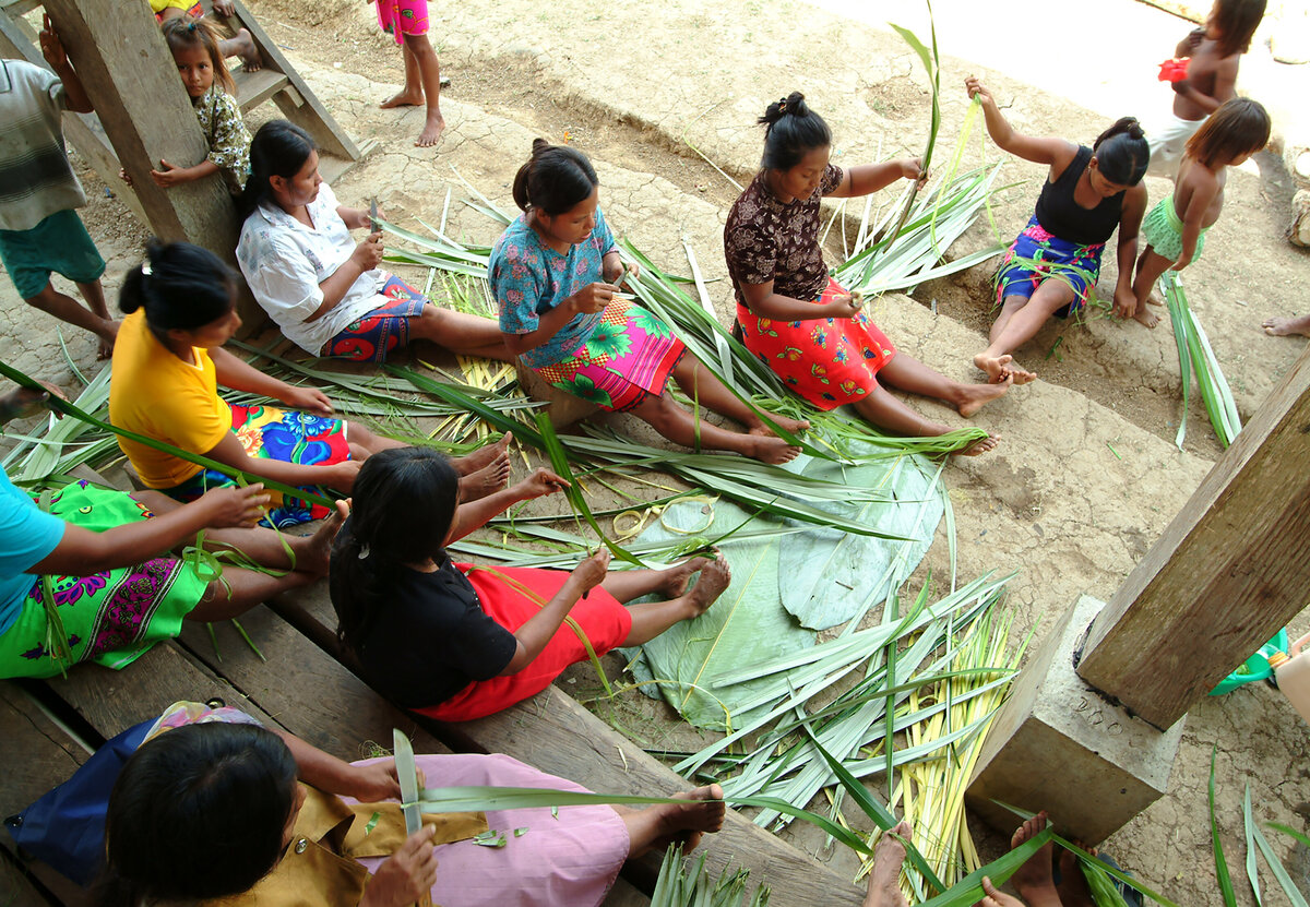 Village women strip palm leaves into hair-fine filaments