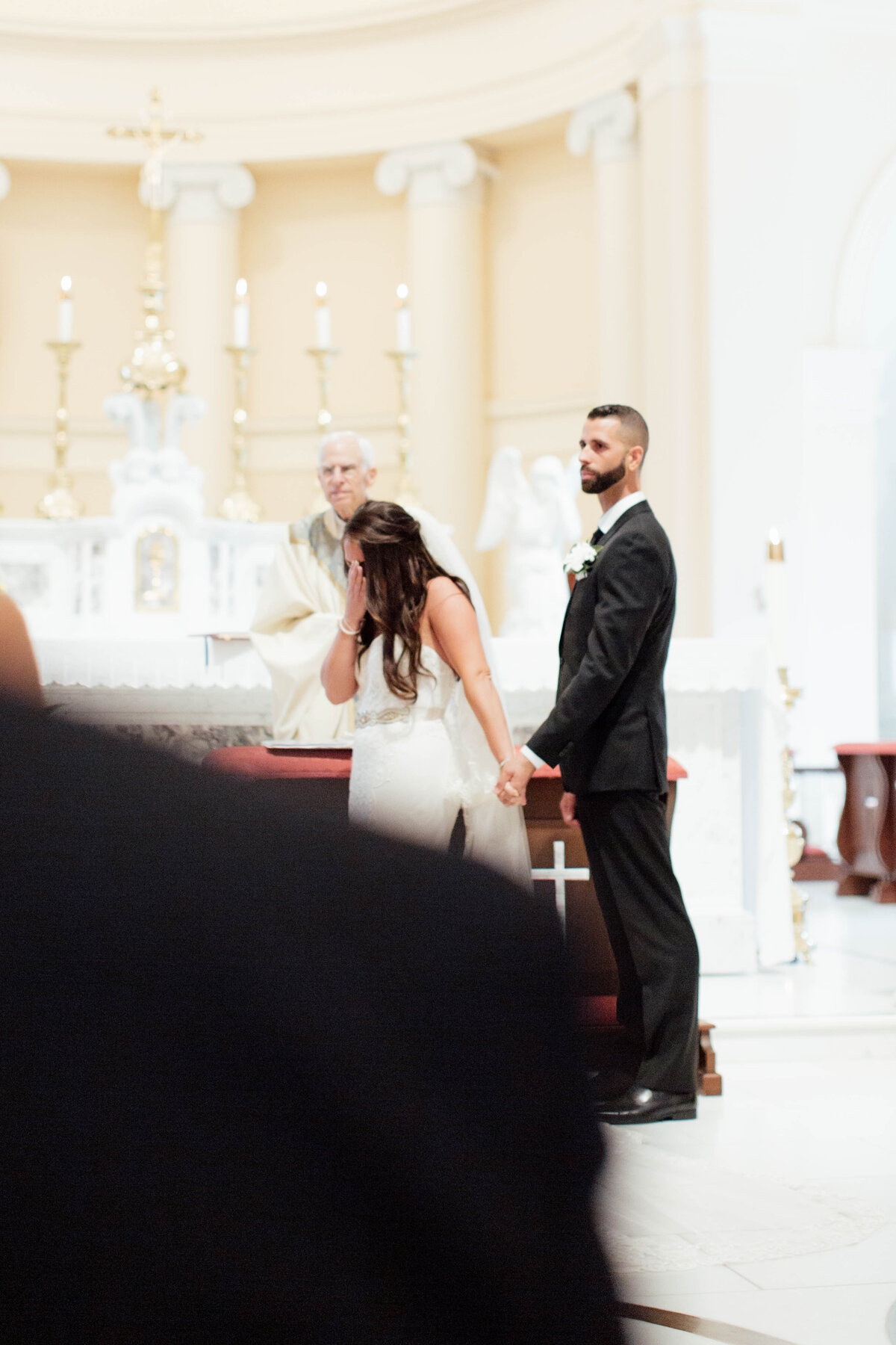 Bride tearing up during ceremony.