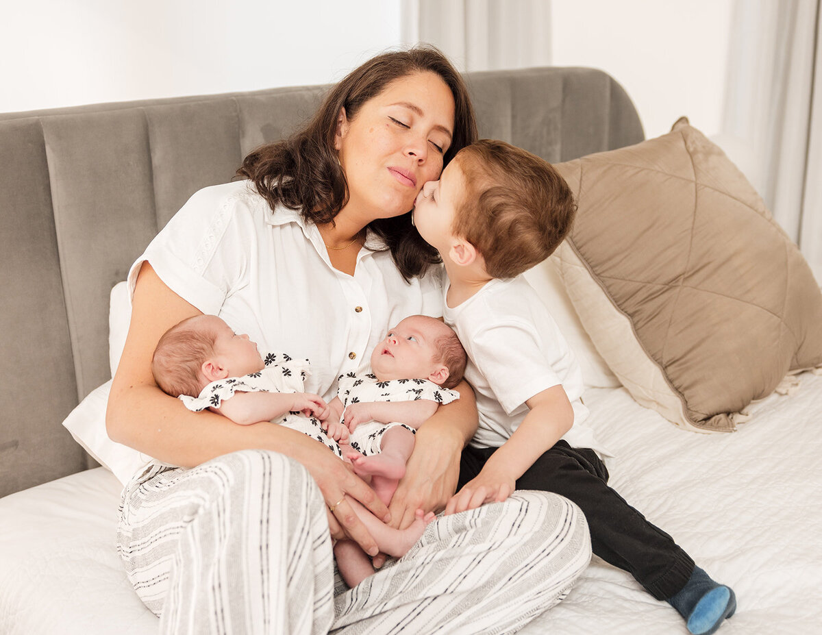 Mother holding newborn during in-home lifestyle photo session in Central Florida

