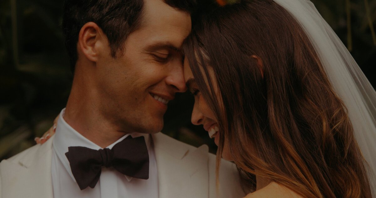 bride and groom smile and embrace