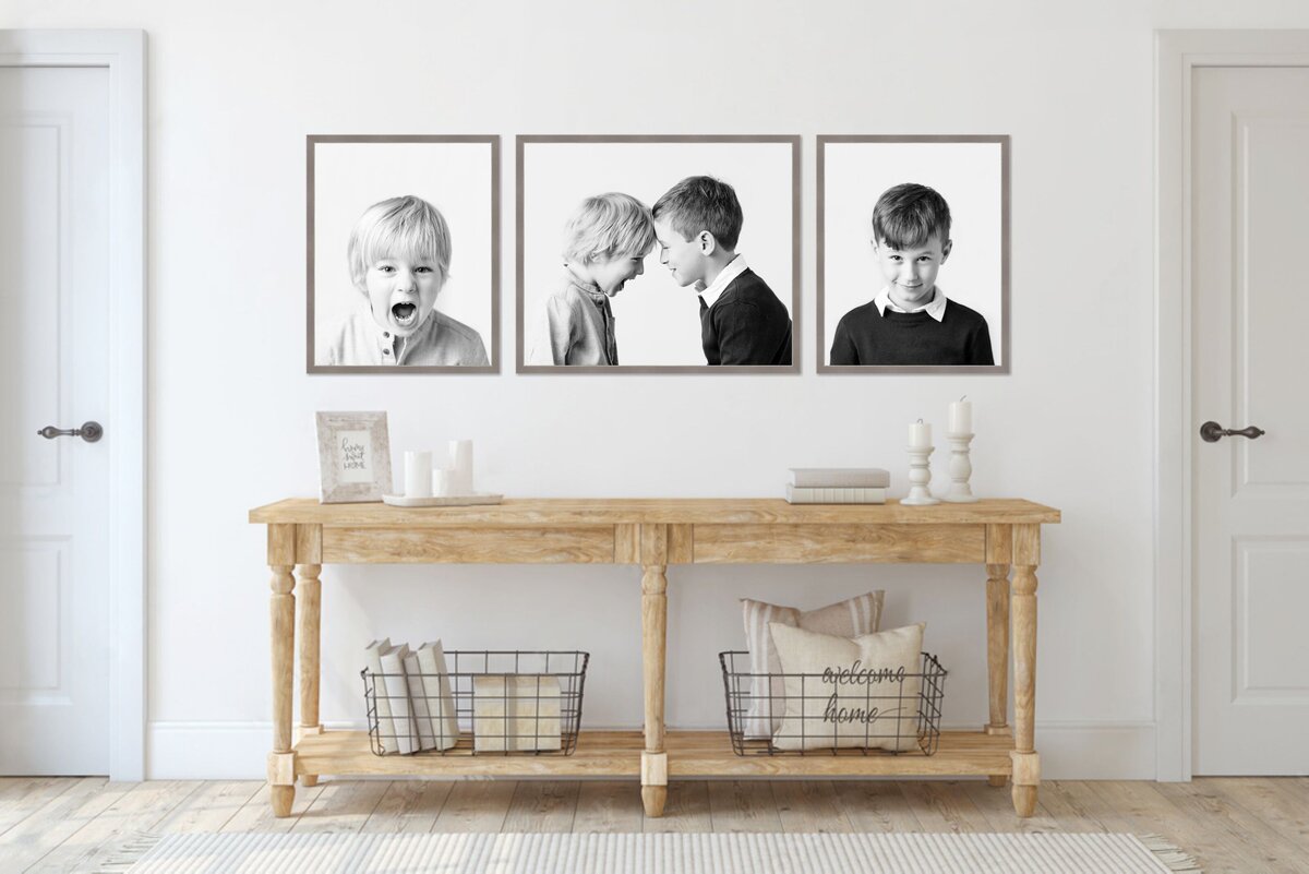 room view with 3 large portraits over a sofa table