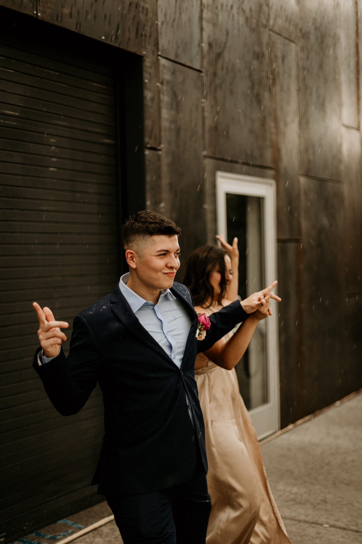 bride and groom dancing in front of a black door in downtown Albuquerque