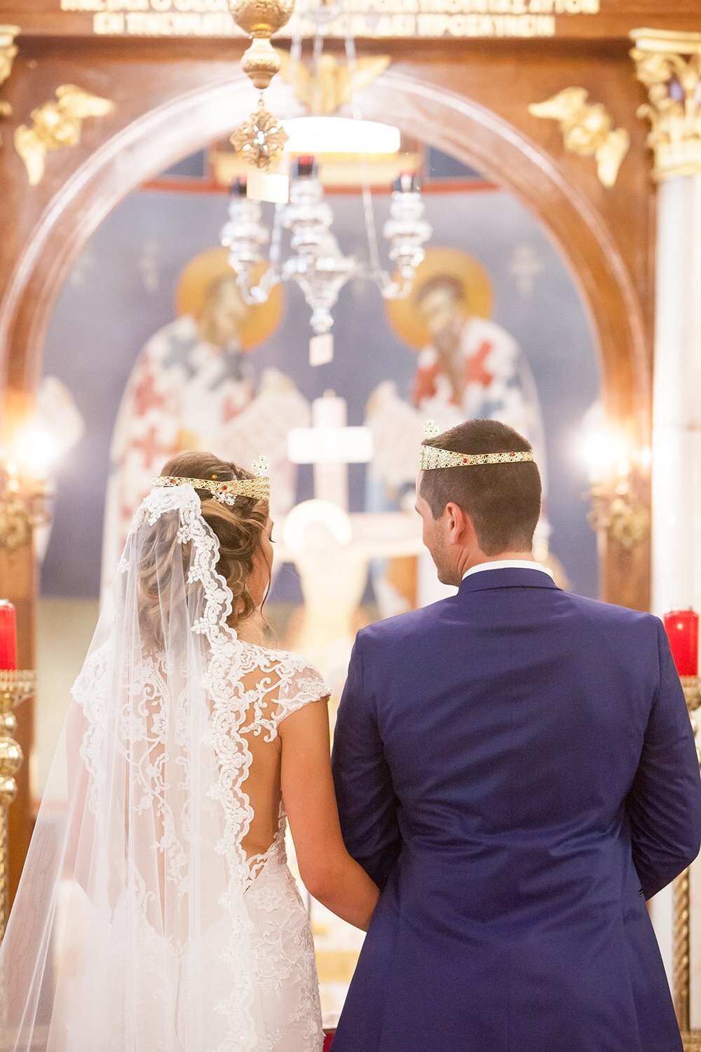 birde and groom wear crowns during their Greek Orthodox Wedding Ceremony in Columbus Ohio