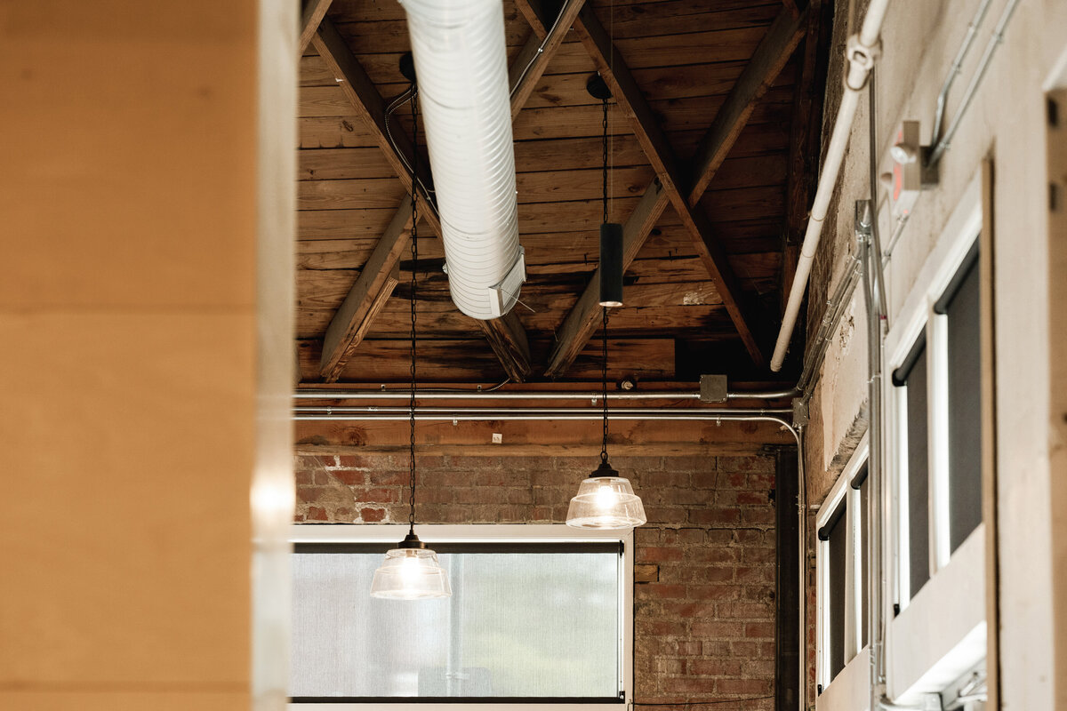windows in a renovated office building in a brick wall with wood ceiling