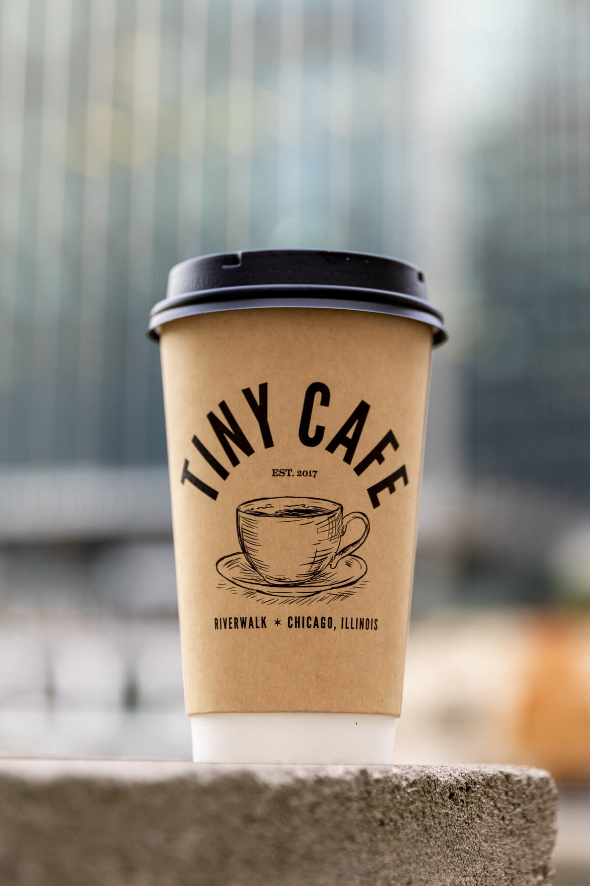 Tiny Cafe to-go cup hero shot in downtown chicago.