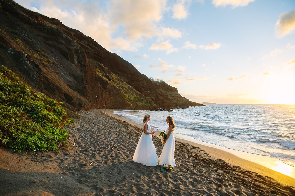 A same sex lesbian couple stands on the beach during their sunset ceremony in Hawaii