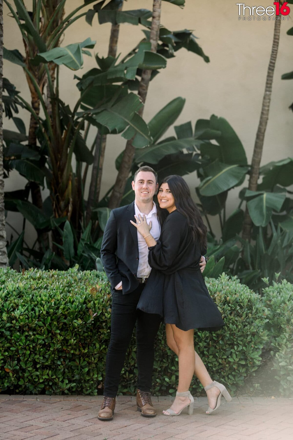 Engaged couple cozy up as the Bride to be shows off her engagement ringand at Pelican Hill Resort in Newport Coast.