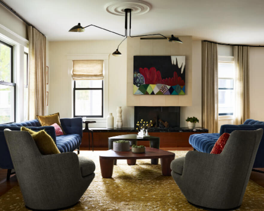 Modern living room interior designers in Boston, MA, blended modern, retro, vintage, and custom pieces with a new gas fireplace for a curated, timeless space.
