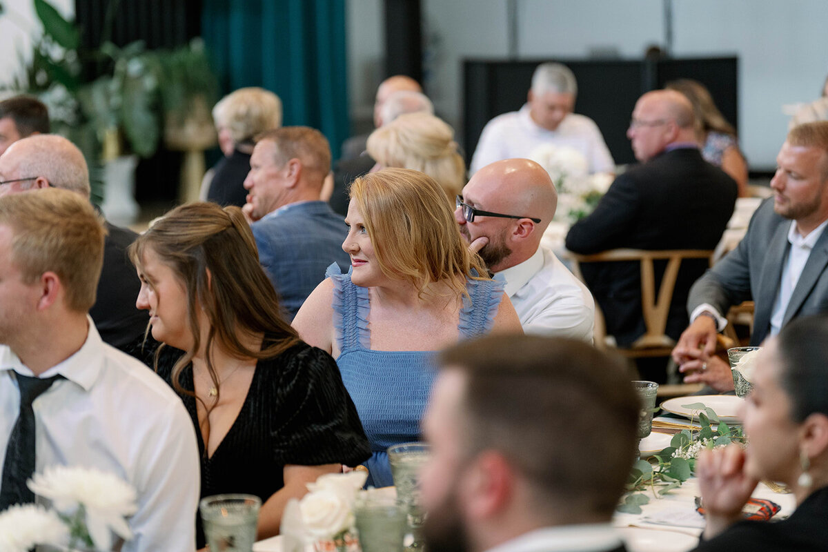 Guests laughing and enjoying the reception during a fall Leona Road wedding in Grand Rapids, Michigan.