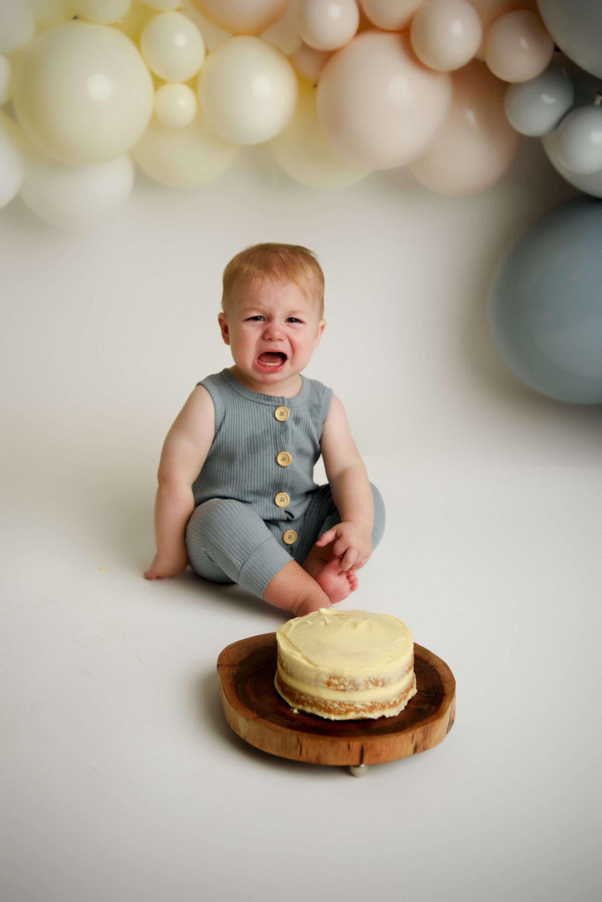 One year old crying during cake smash