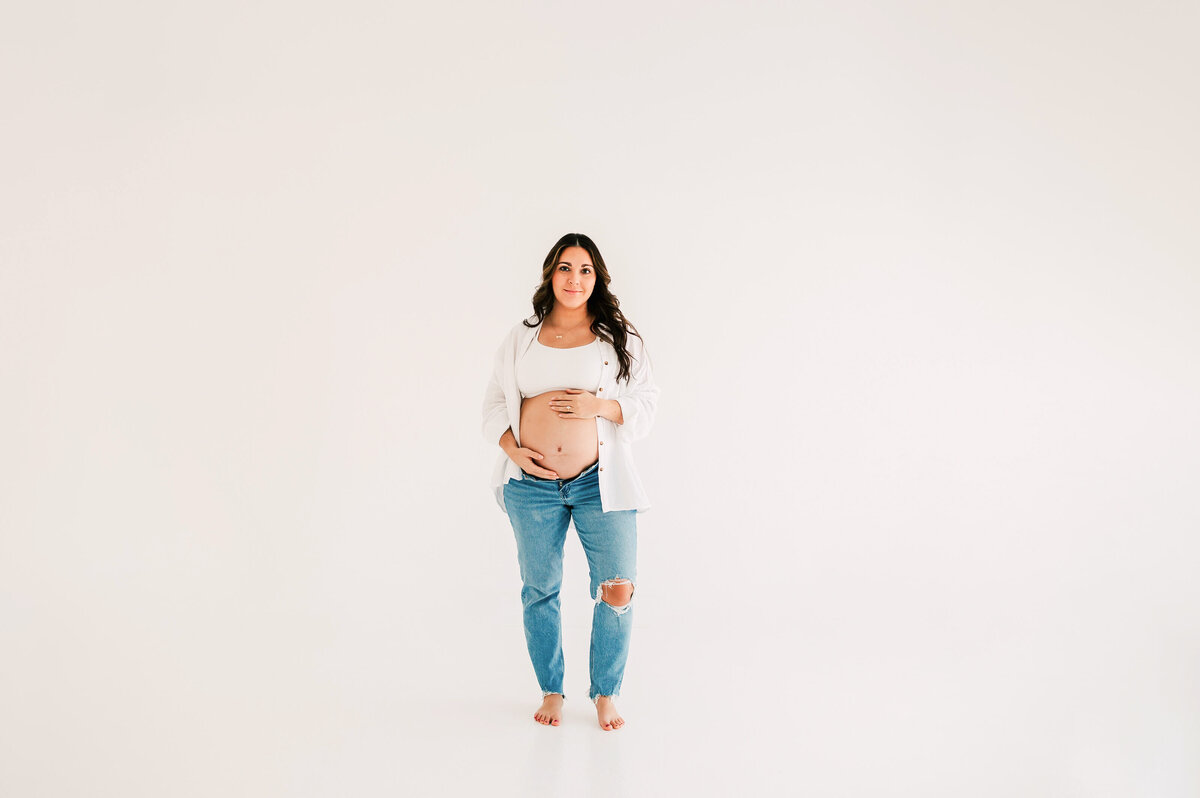 pregnant mom in jeans  during Springfield Mo maternity photography session