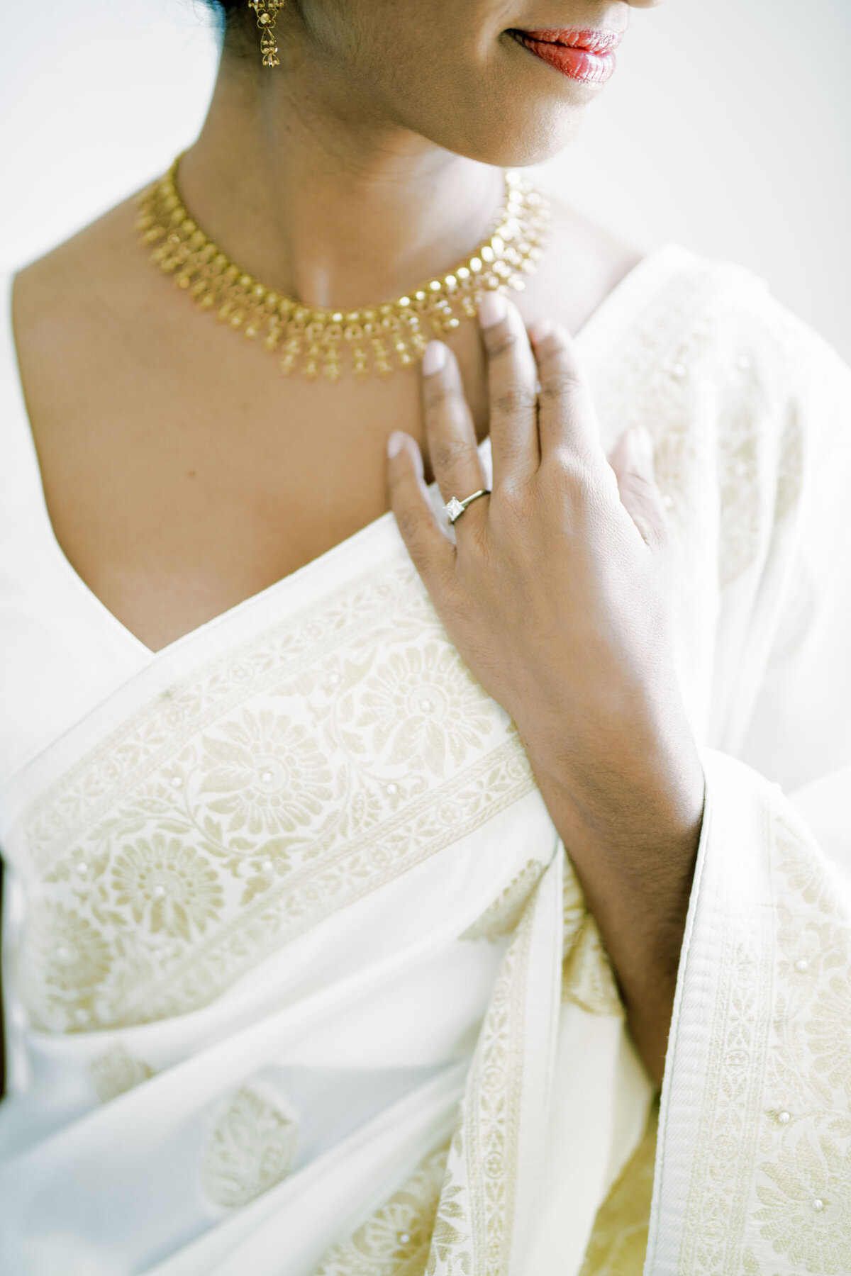 bride has hand on dress that is getting ready for the day