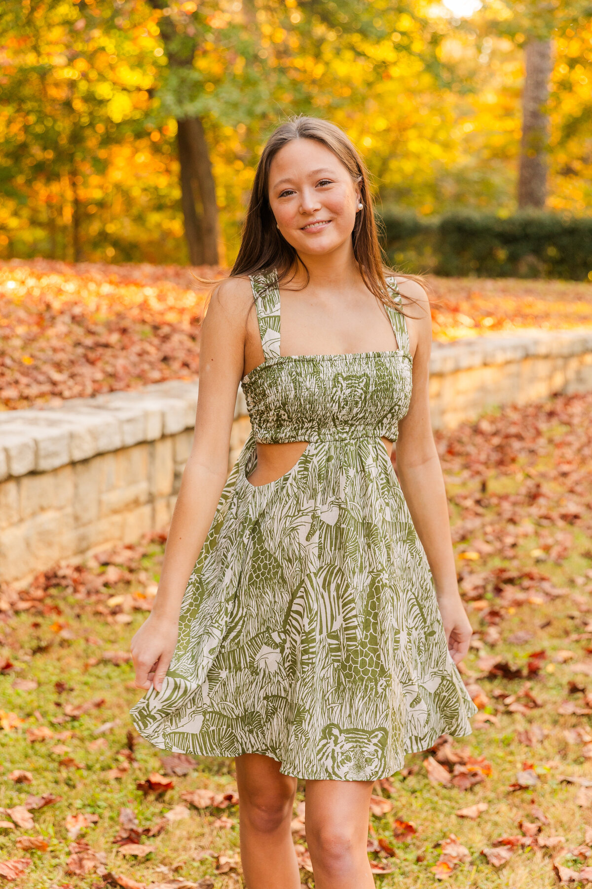 senior girl twirling and playing with her dress during portrait photo session