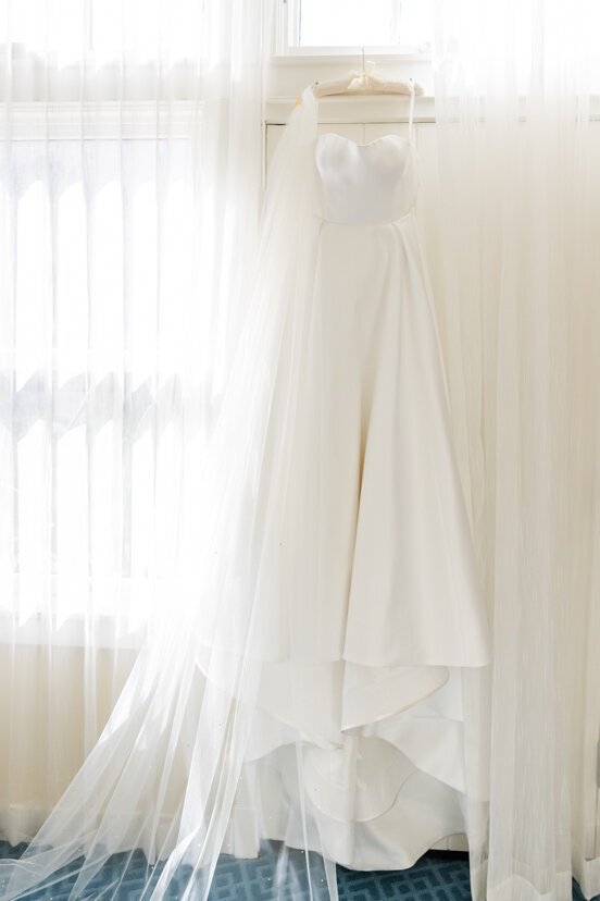 wedding-dress-hanging-by-window