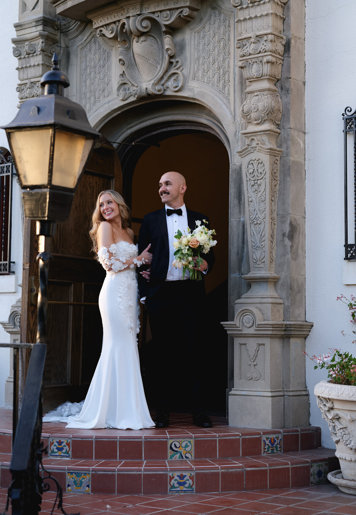 Bride and groom standing in a door way at Muckenthaler Mansion Wedding