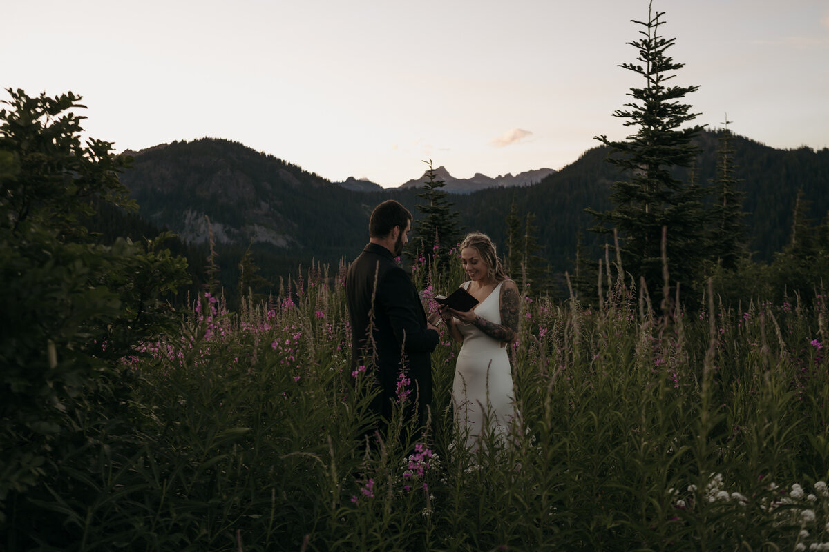 Bride and groom standing on top of Rattlesnake Ledge in Snoquamie National Forest