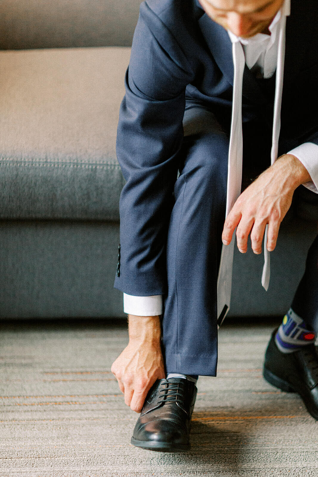 groom-puts-on-shoes-wedding-day-Cape-Breton