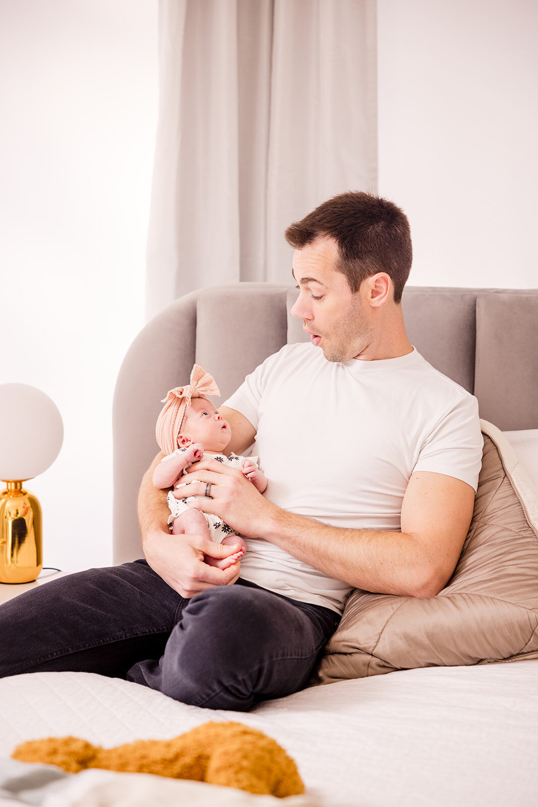 Father snuggling baby girl during relaxed in-home photo shoot in Orlando


