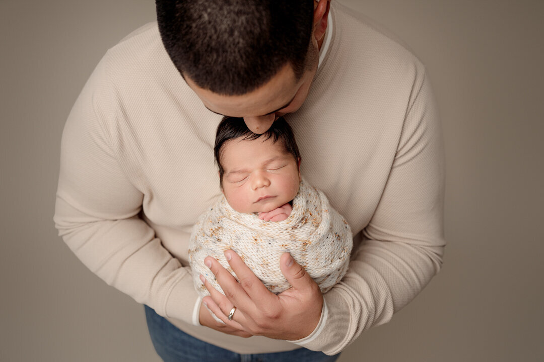 Grand Rapids Newborn Photography Dad kissig baby by For the Love of Photography