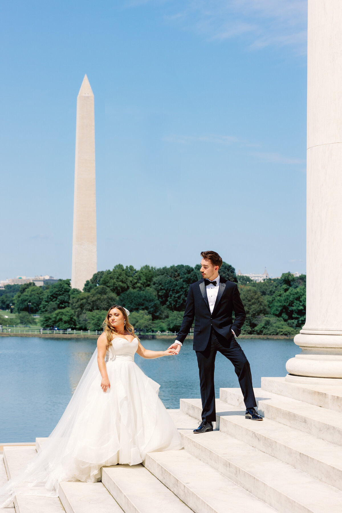 Bride and groom stand in front of washington monument