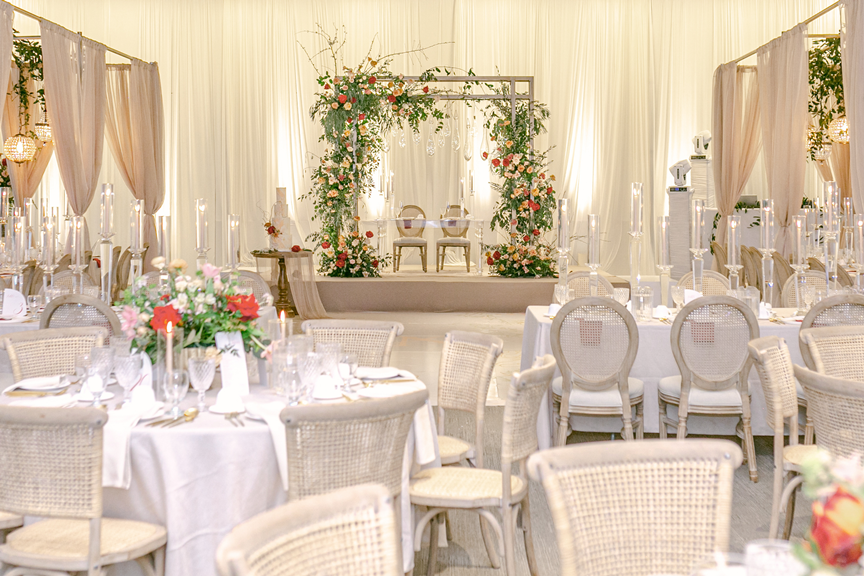 kavita-mohan-ivory-gold-orange-greenery-wedding-reception-sweetheart-table-draping-cake-chandelier