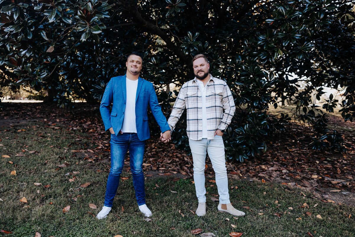 Nashville engagement photographer captures men holding hands during outdoor engagement session in Nashville