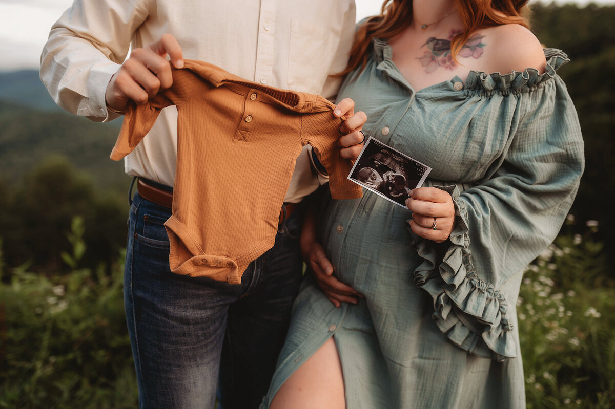 Expectant parents pose for Maternity Photos on the Blue Ridge Parkway in Asheville, NC.