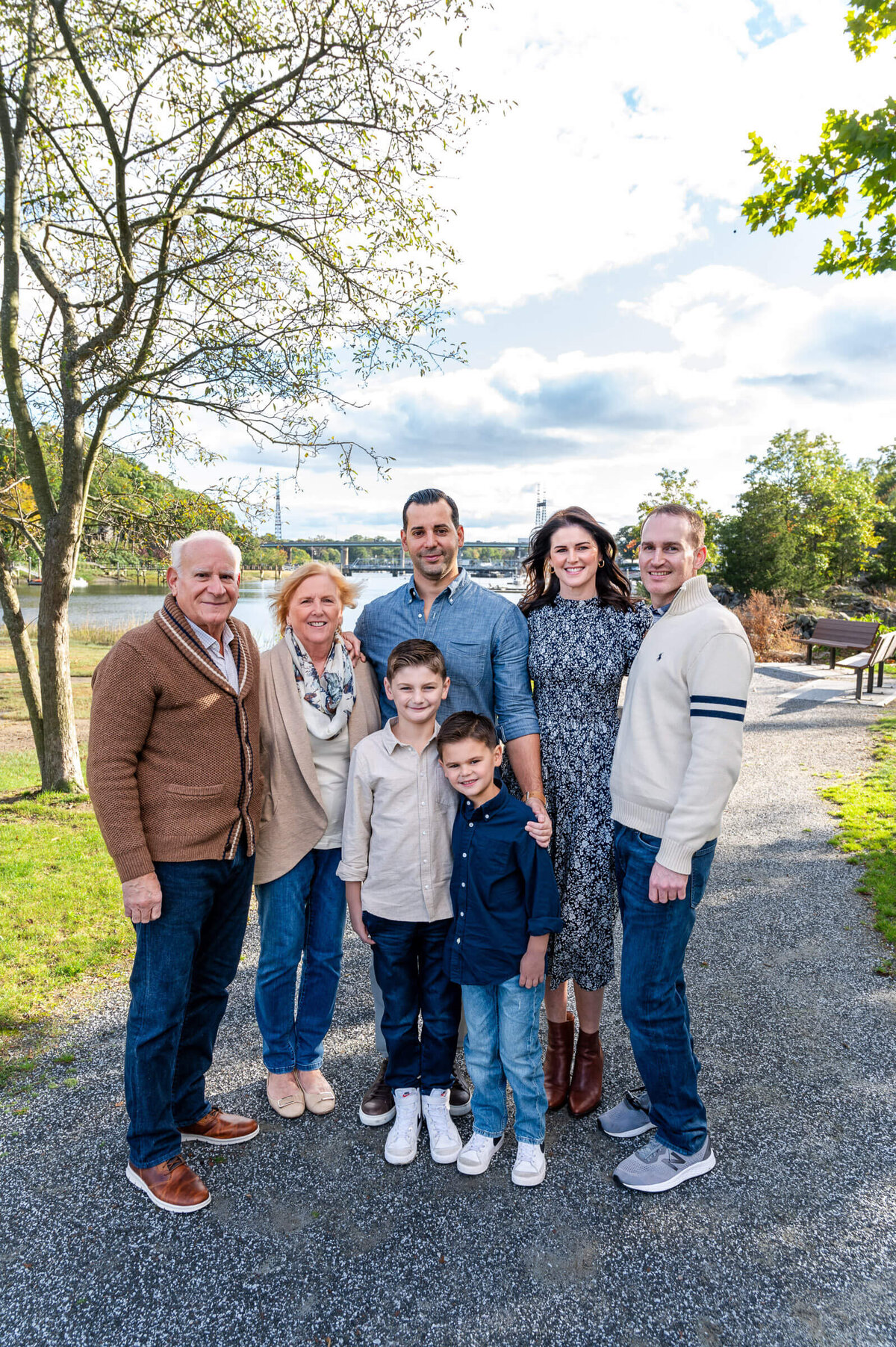 Extended family standing, smiling next to each other in Westport, CT.