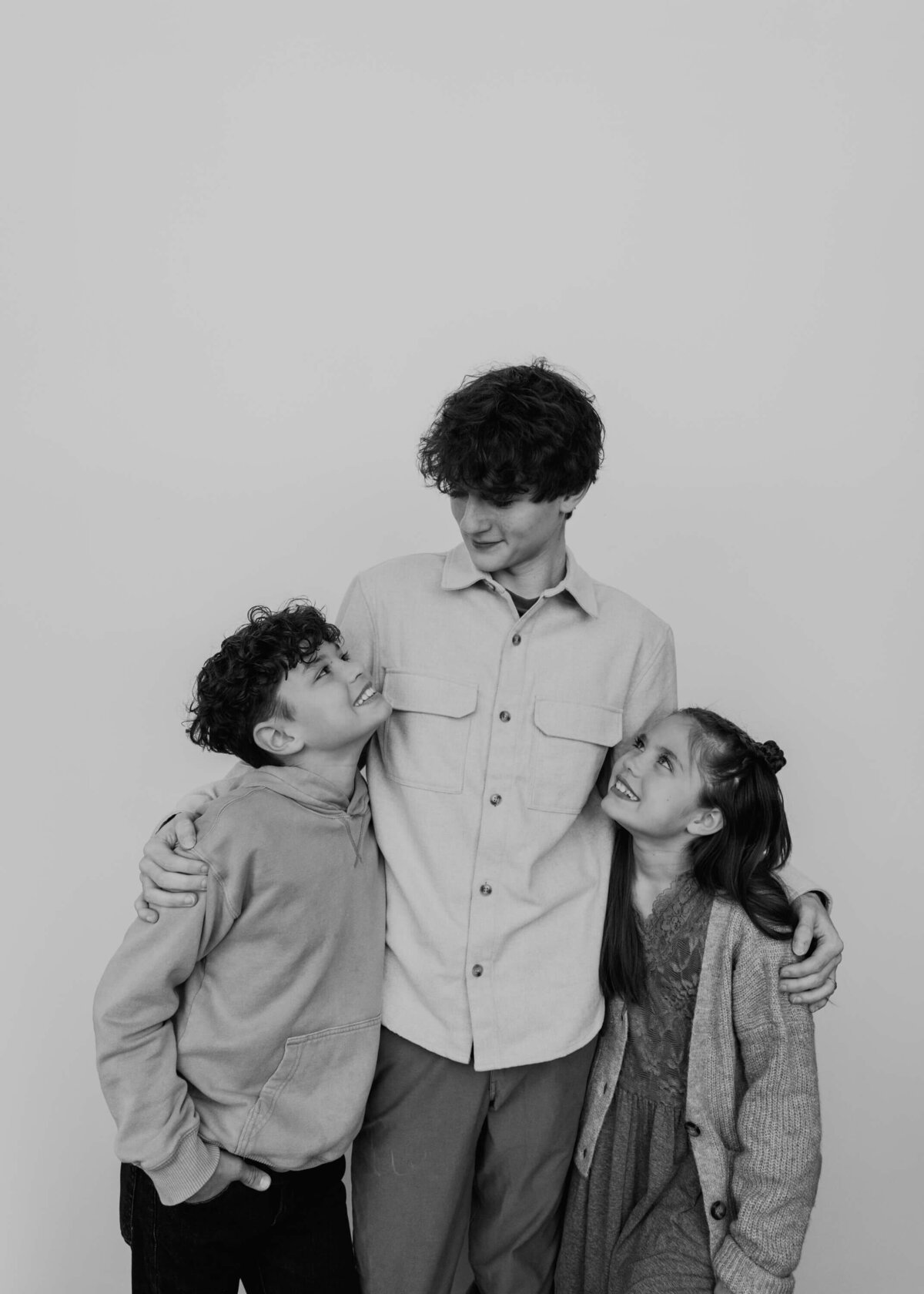 little siblings looking up admiringly at big brother