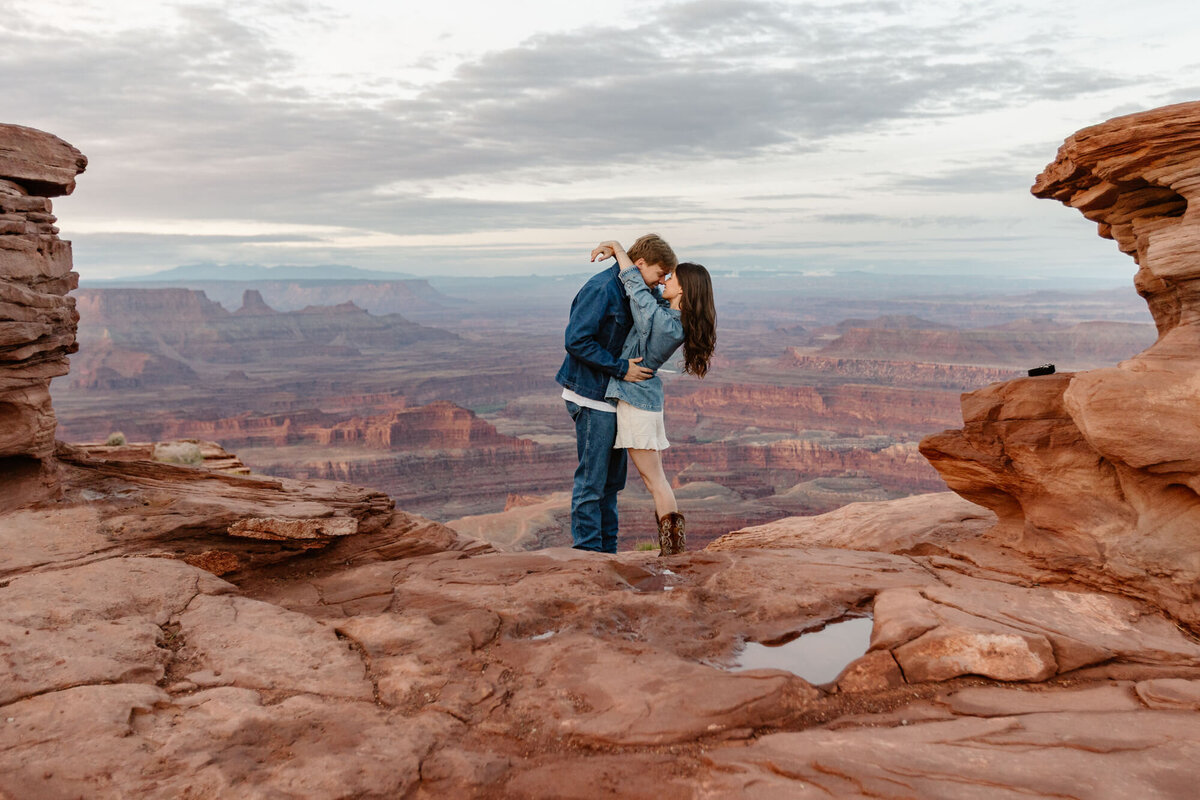 A couple snuggling at Dead Horse Point on their elopement day. 