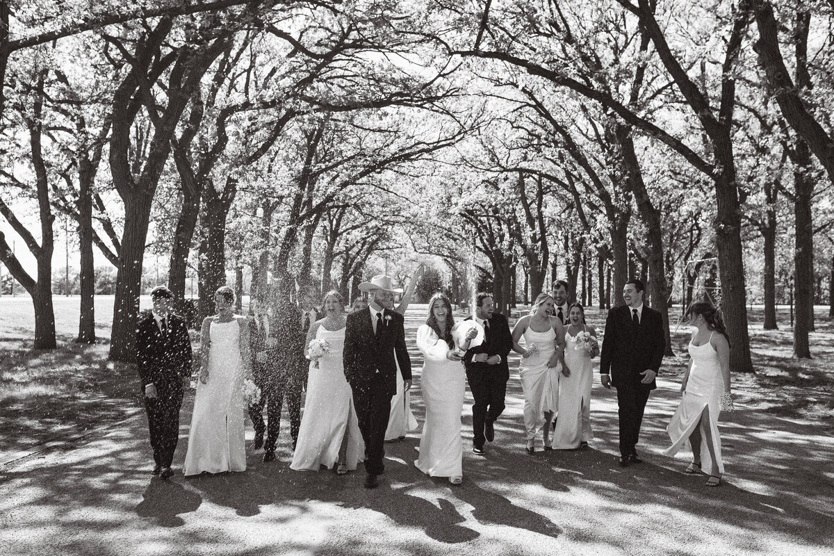 family outdoor wedding photo f everyone cheering and happy for the bride and groom.