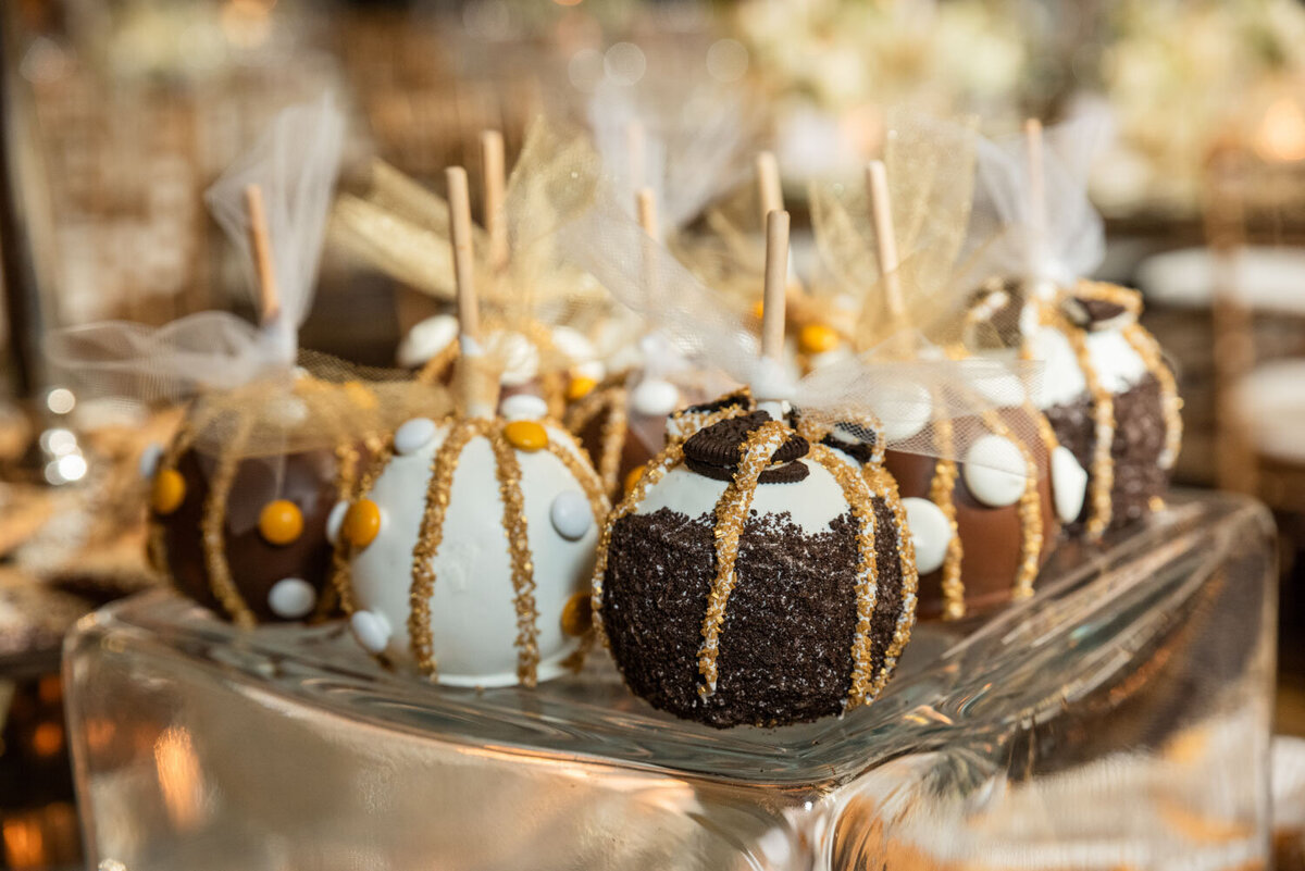 A bunch of chocolate covered apples on a glass plate