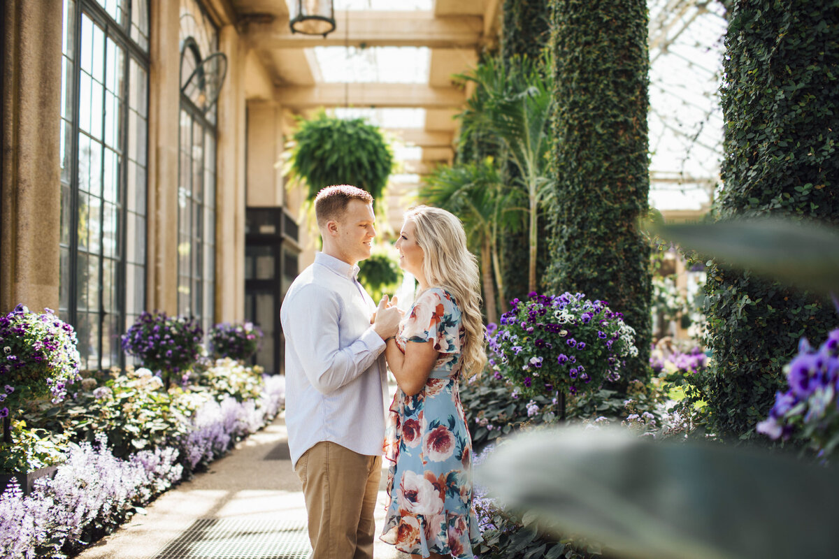 Couple holding hands during engagement session at Longwood Gardens in Kennett Square Pennsylvania