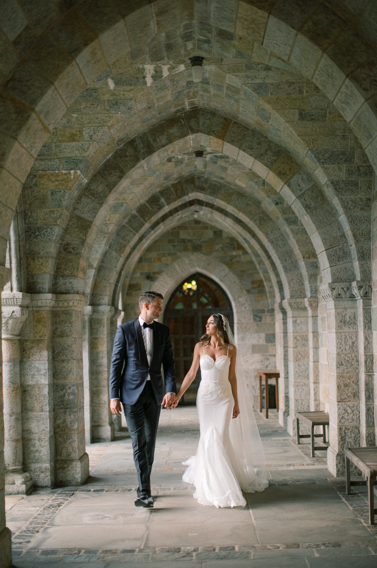 bride and groom walking hand in hand throughout wedding venue