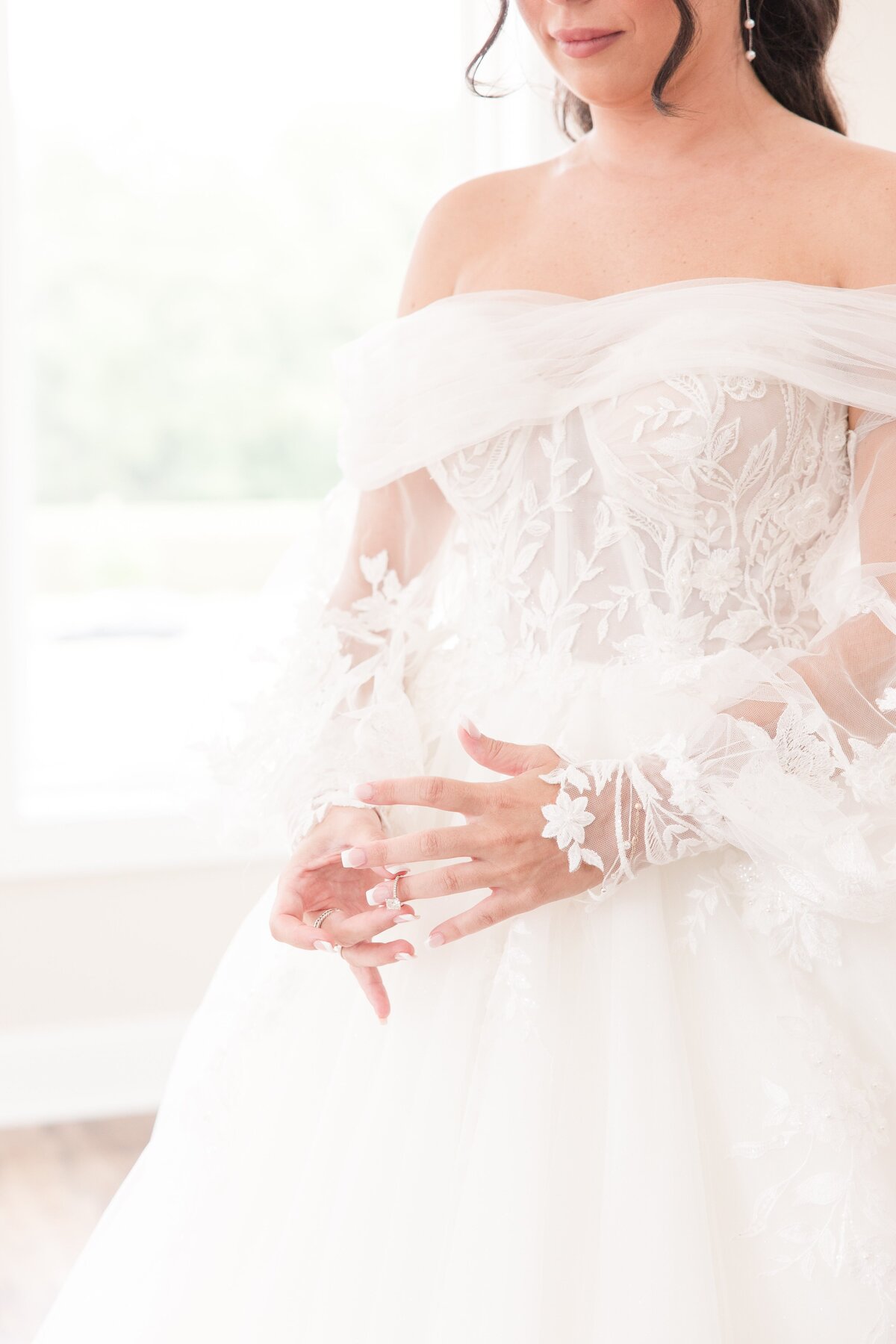 bride playing with engagement ring on wedding day