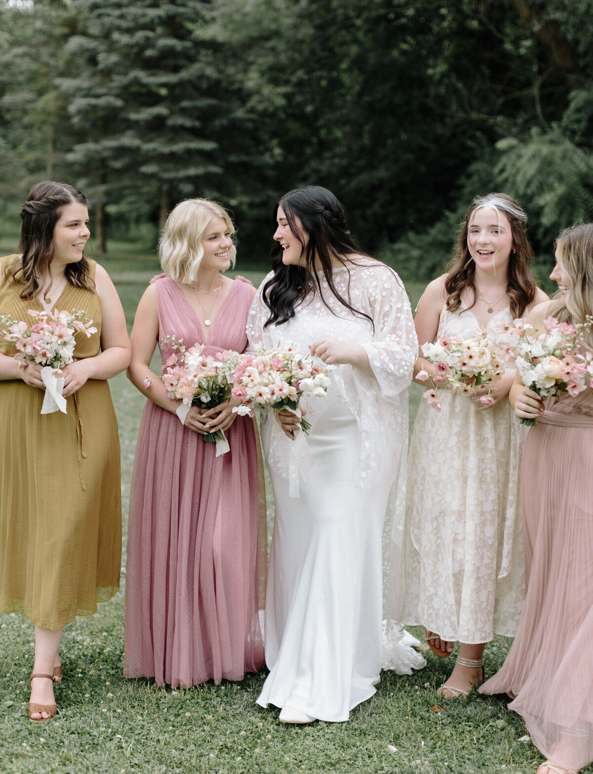 bridesmaids in different dresses, warm tones, pink, greenhouse wedding venue in Grand Rapids