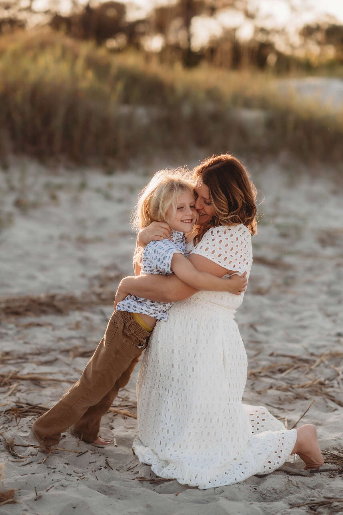 Mother embraces her son during Family Portrait Session on Folly Beach.