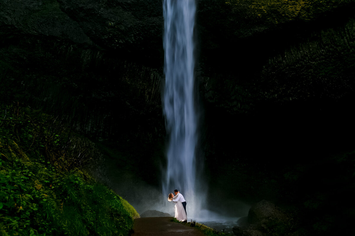 Oregon Waterfall behind bride and groom in Portland