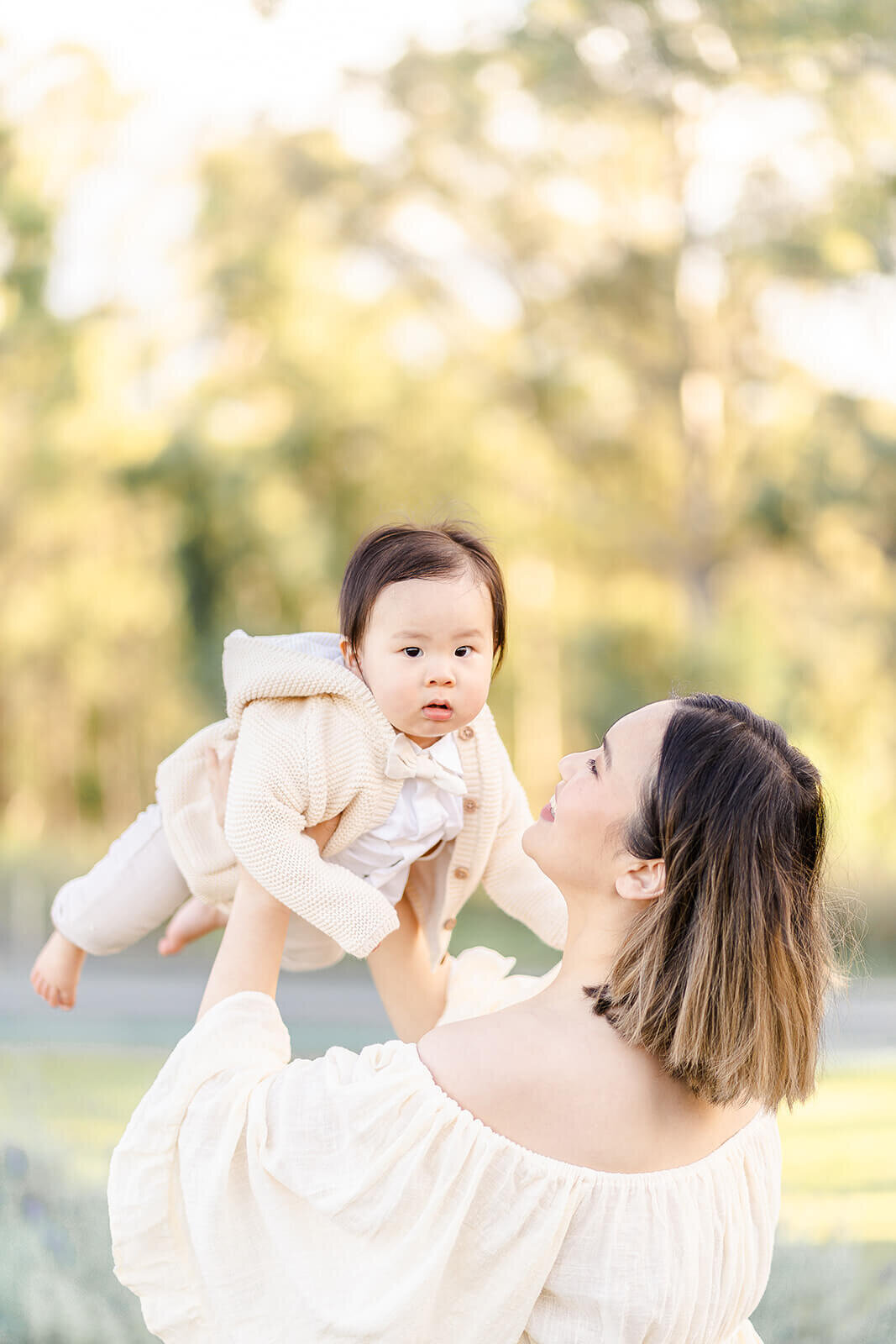 Candid shot of mum throwing baby in air during family session in Brisbane lavender field, Mount Cotton.