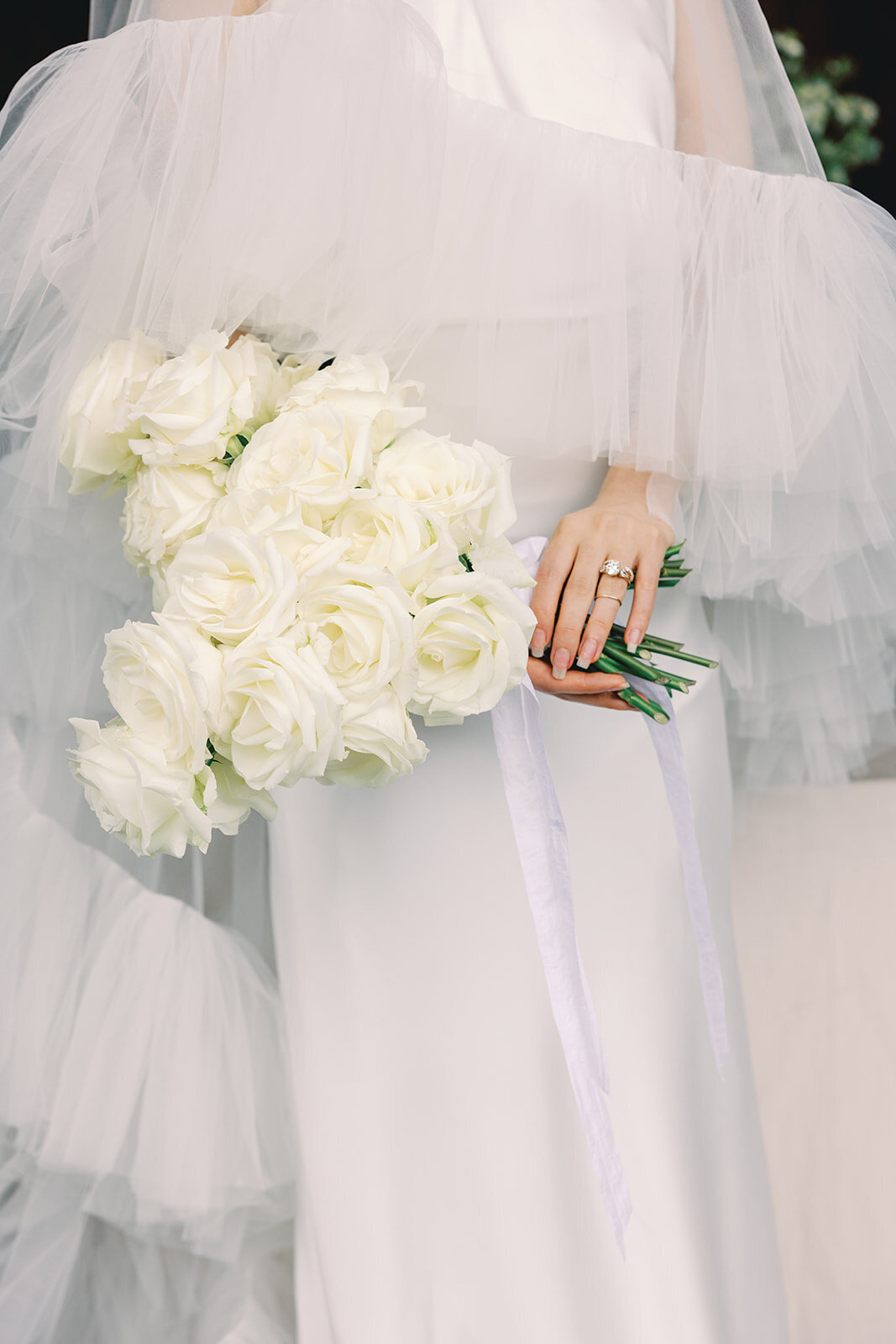 Bride holding a bouquet of white flowers