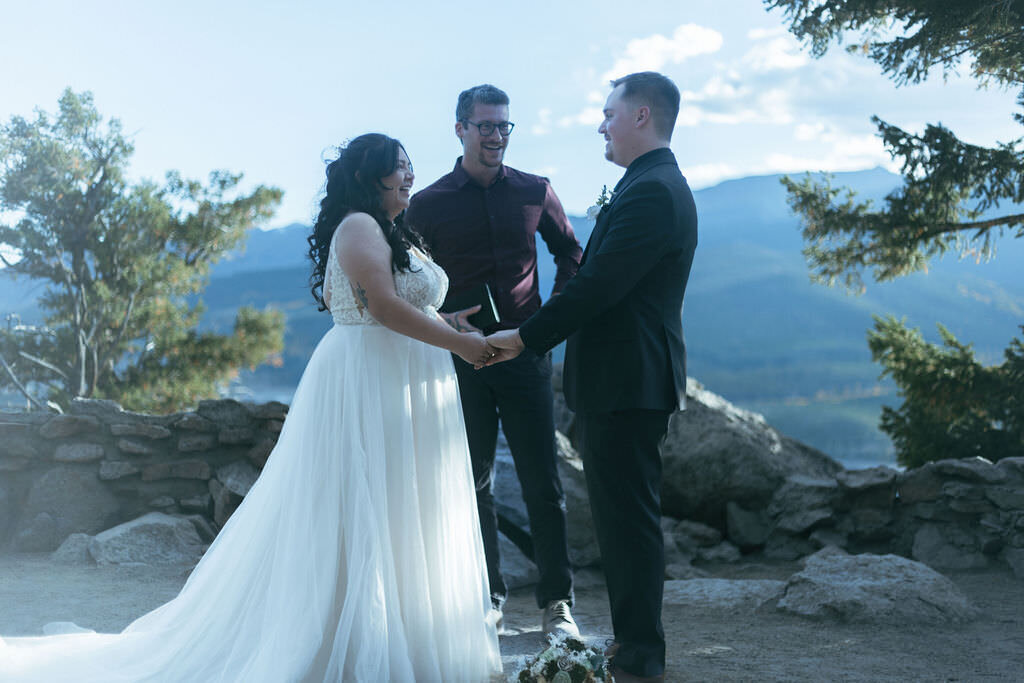 A couple exchanging vows in the mountains.