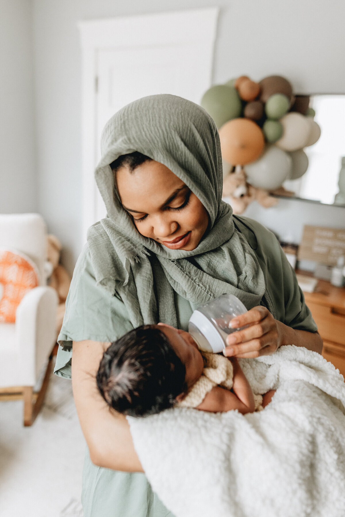 Newborn photography of mother holding newborn babe.