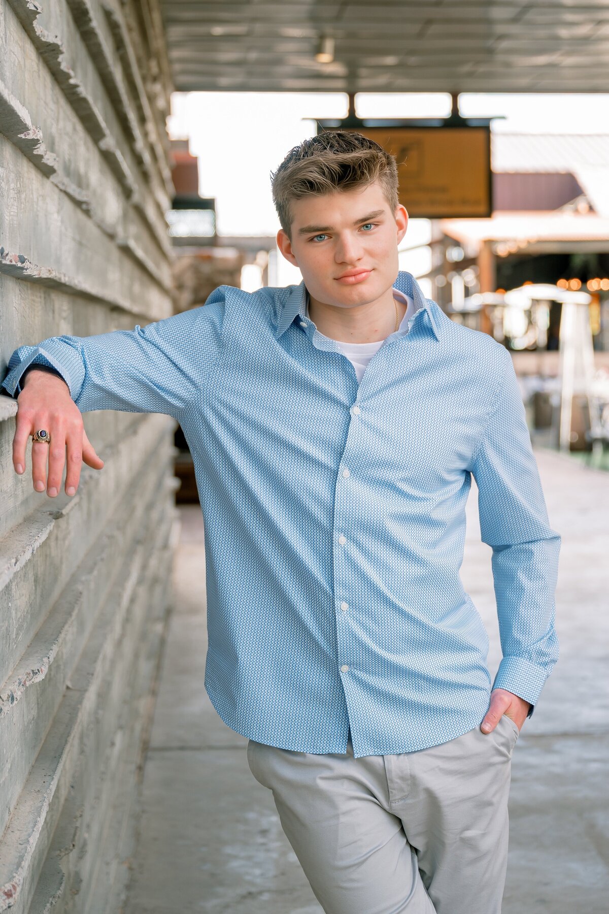 senior boy posing at marketstreet in DC Ranch 