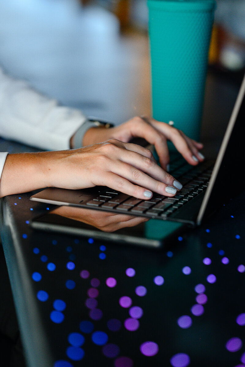 Commercial photographers in Denver capture a woman's hands on her laptop during a brand photography session for branding pictures for her denver business.