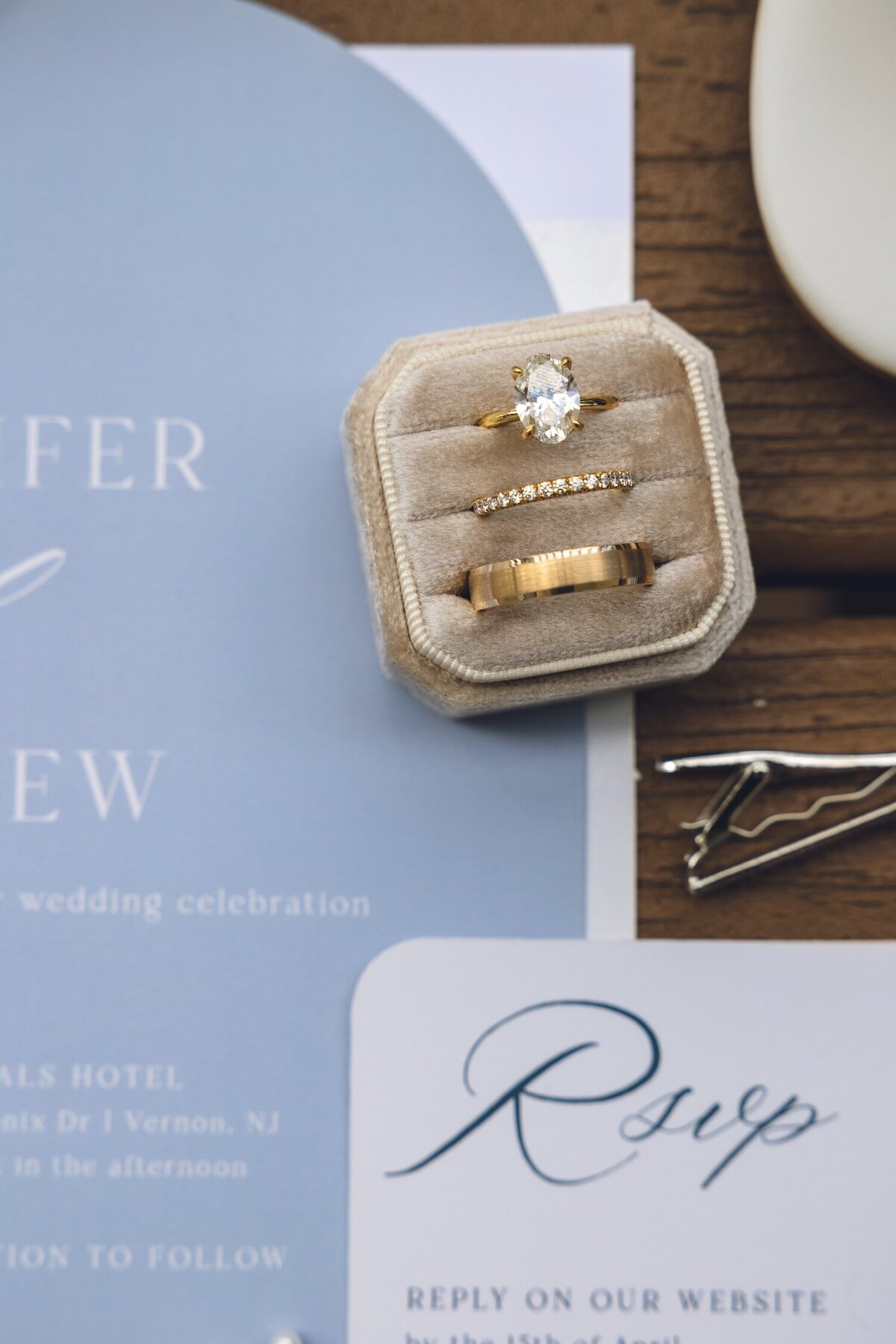 Wedding rings displayed on velvet box with invitation at Crystal Springs Resort