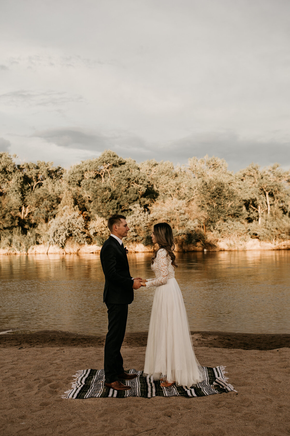 bride and groom saying vows by the river